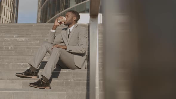 African Man Enjoying Coffee Outdoors