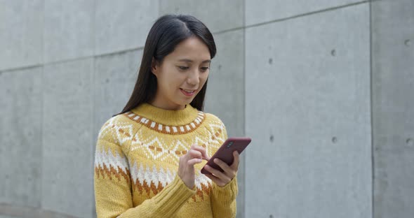 Woman search on cellphone in city