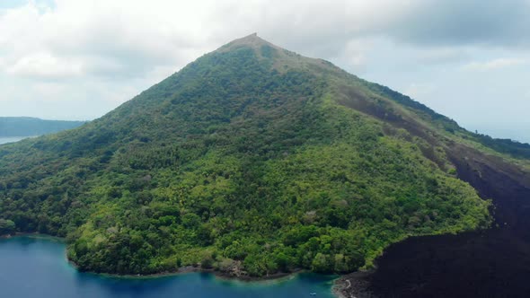 Aerial: flying over Banda Islands active volcano Gunung Api lava flows Indonesia