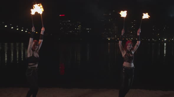 Firegirls Performing Fireshow with Lit Torches