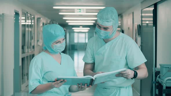 Surgeons are Browsing the Documents in the Corridor