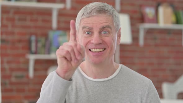 Cheerful Senior Old Man Pointing Finger