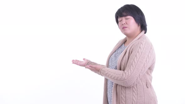 Stressed Overweight Asian Woman Showing To the Back for Winter