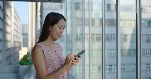 Woman check on mobile phone inside shopping mall