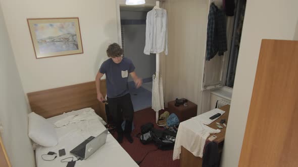 Young man dancing in dorm room