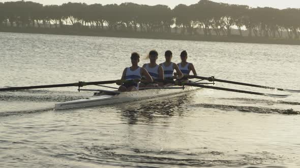 Female rowing team training on a river