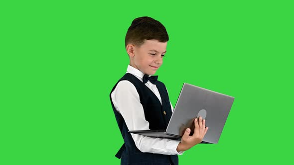 Smiling Boy Bow Tie Waistcoat Using Laptop Computer While Standing Green Screen Chroma Key