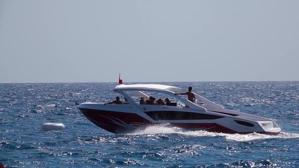 Tourist Boat with People Floating on the Waves. Slow Motion