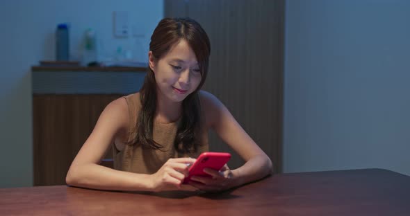 Woman check on mobile phone at night