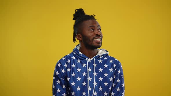 Happy African American Man with Toothy Smile Looking to the Left and to the Right and Turning to