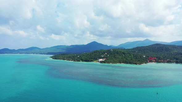 Luxury fly over clean view of a white paradise beach and blue water background in colourful 4K