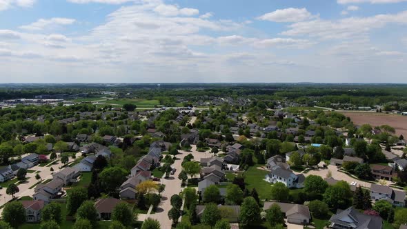 Forwarding Aerial drone shot of beautiful neighborhood in Wisconsin on bright sunny day