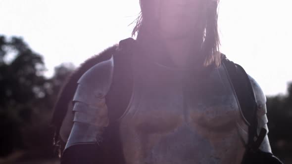 Portrait of independent warrior princess. Medium shot agains the light