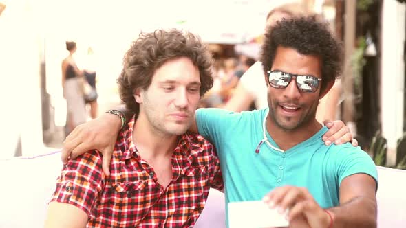 Three young adults having fun taking spontaneous selfies