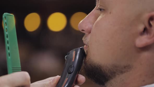 Barber Cutting Beard Using Electric Trimmer Makes Haircut for Groom Man Customer at Barber Shop