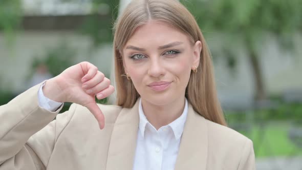 Outdoor Portrait of Young Businesswoman Showing Thumbs Up Sign