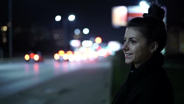 Lonely Woman Smiling While Waiting on Bus Stop, Talking with Bluetooth Handsfree Earphones Concept