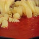 Putting pasta penne in pan with tomato sauce in pan, close up - VideoHive Item for Sale
