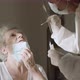 Doctor Video Footage - Elderly Woman Doing A Swab Test - VideoHive Item for Sale