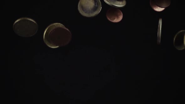 Metal coins falling on table