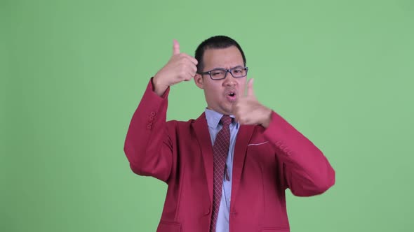 Happy Asian Businessman with Eyeglasses Giving Thumbs Up and Looking Excited