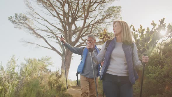 Active senior couple hiking in forest