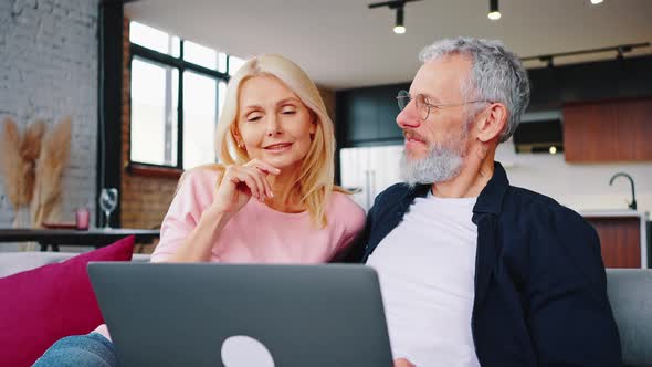 Indoor Portrait of Affectionate Middleaged Couple