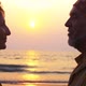 Silhouette of Senior Couple Standing on the Beach and Talking at Sunset - VideoHive Item for Sale
