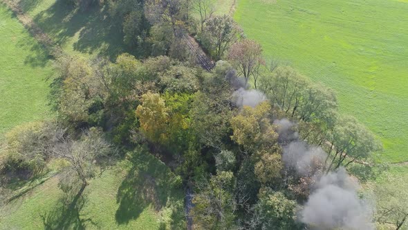 Antique Restored Steam Engine Traveling Thru Trees Blowing Smoke