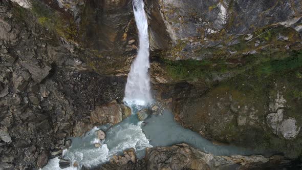 Chame waterfall flowing into the Marsyangdi River from aerial view