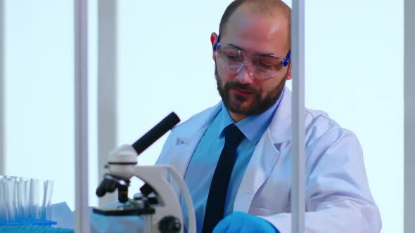 Close Up of Tired Man Doctor Working in Scientific Laboratory