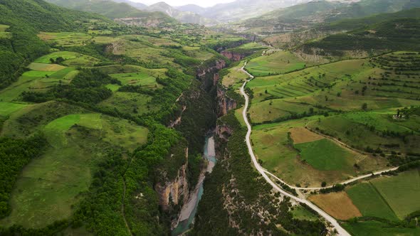 Aerial cinematic Eagle eye-shot of the Osum Canyon in Albania with a river flowing through the dense
