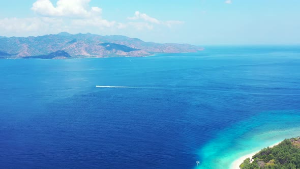 Tropical drone clean view of a white paradise beach and aqua blue water background in high resolution