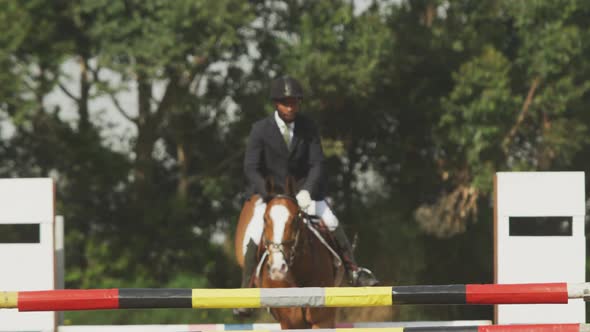 African American man jumping an obstacle with his Dressage horse