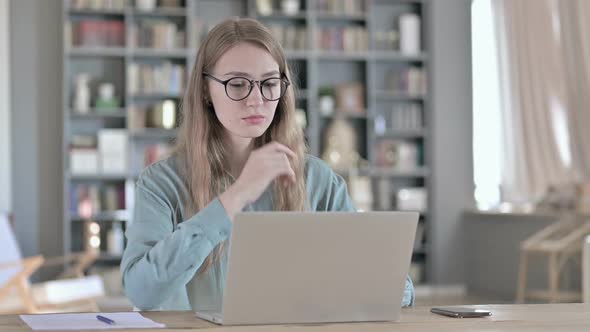 Portrait of Woman Thinking and Working on Laptop