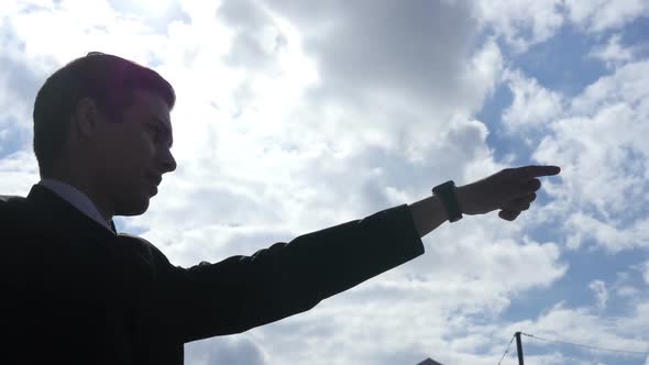 Silhouette of Businessman Showing Direction, Leader Pointing with Finger,