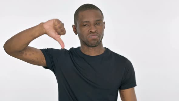 Thumbs Down By Young African Man on White Background