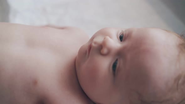 Adorable Newborn Boy with Short Fair Hair and Blue Eyes