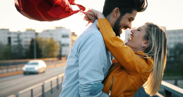 Couple in Love Cuddling While Enjoying Beautiful Urban Sunset Together