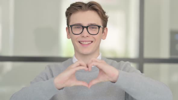 Portrait of Young Man Showing Heart Shape By Hands