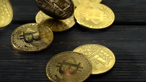 Lot of Bitcoin Coins Falls on the Wooden Surface. Close Up