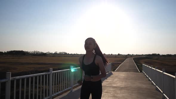 Silhouette woman running on the bridge