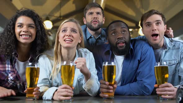 Cheerful Friends Clinking Beer Glasses, Celebrating Team Victory in Bar, Leisure