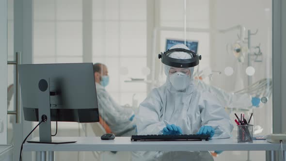 Portrait of Dental Assistent Typing on Computer Keyboard