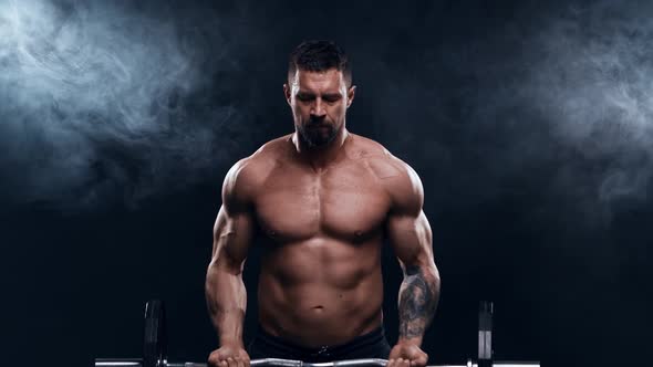 Fit and sporty bodybuilder over black background.