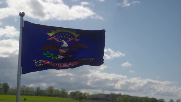 Flag of North Dakota State Region of the United States Waving at Wind