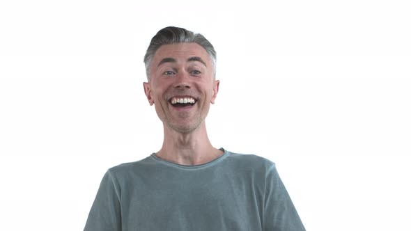 Charismatic Middleaged Man with Grey Hair and Bristle Wearing Casual Clothing Laughing and Having
