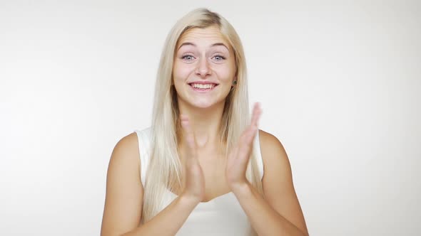 Cheerful Happy Young Woman with Long Blond Hair Expressing Approval Showing Thumbs Up Smiling