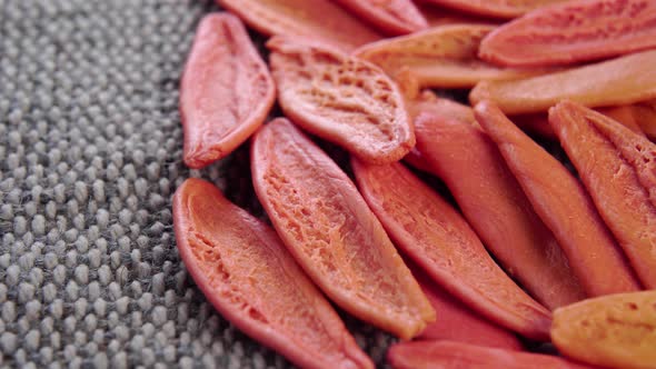 Foglie red handmade macaroni. Tomato dry Italian pasta on a rough jute cloth