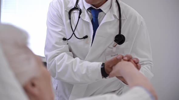 Caring Doctor Holding Hand of Patient